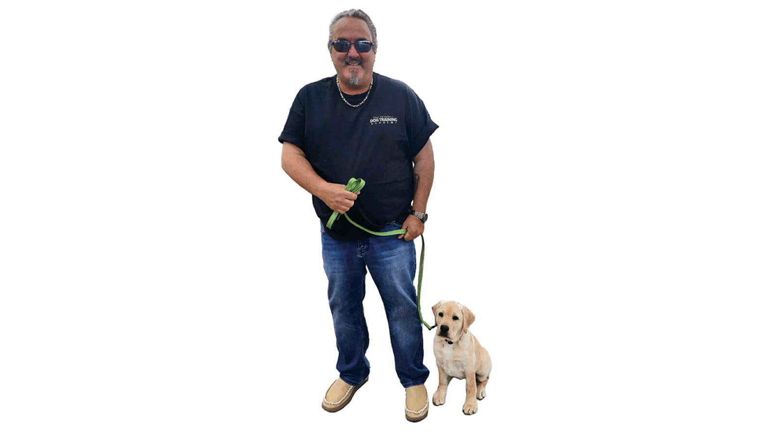 Dave the Dog Man host Dave McMahon standing beside a puppy on a leash