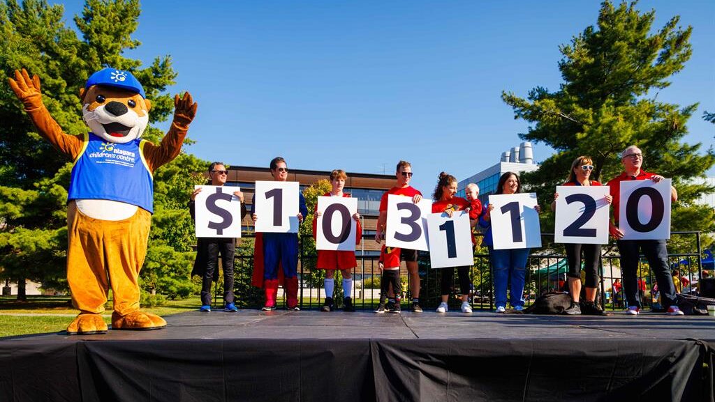 Niagara Childrens Centre Superhero Run participants spell out the total raised over the events 11 years which is now $1,031,120