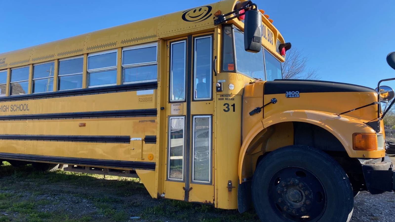 School bus parked in yard.