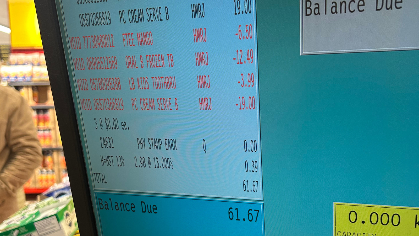 A photo of a cash register screen showing purchases on a grocery bill.