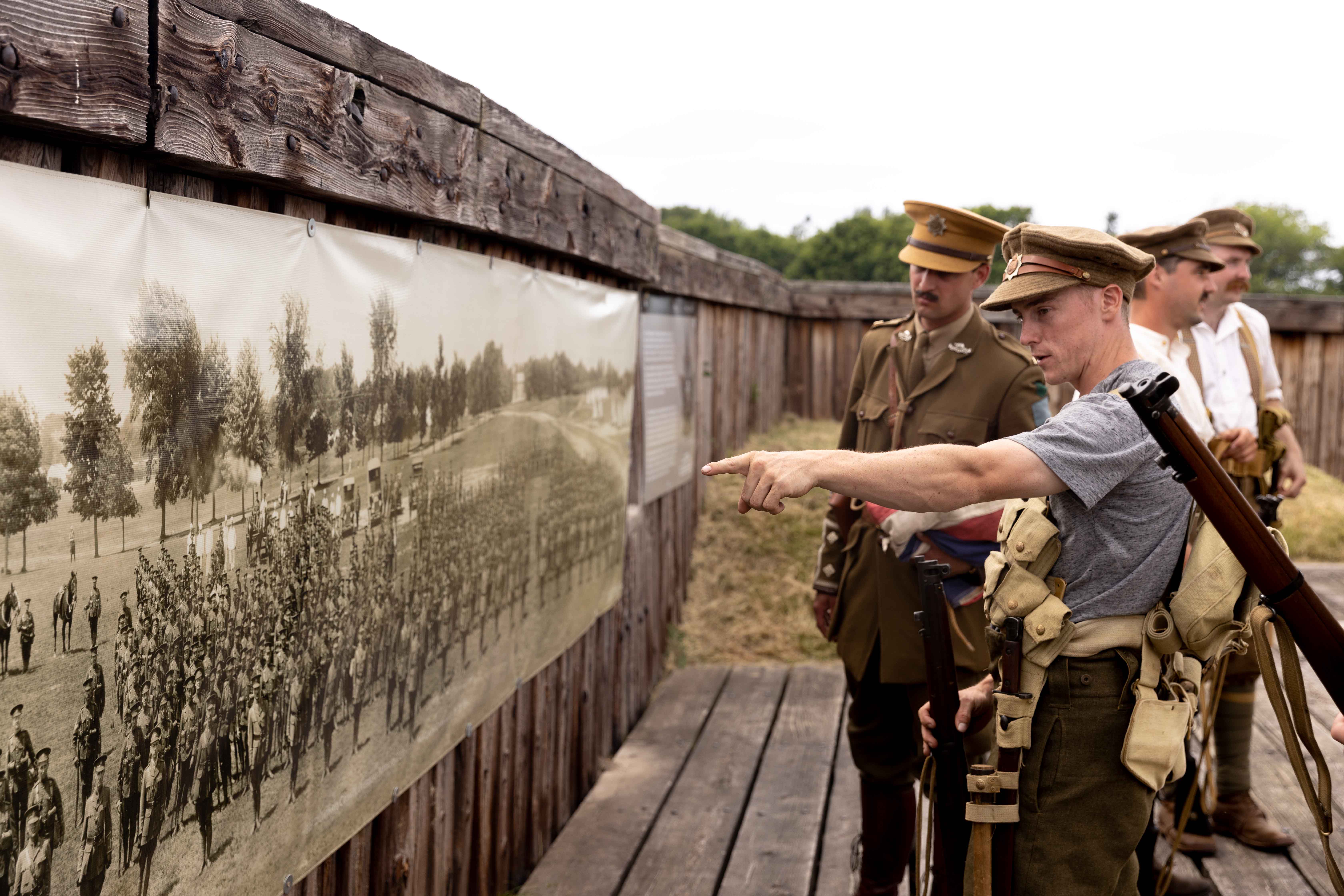 Re-enactors talking about an old photo during the First World War on display at Fort George.