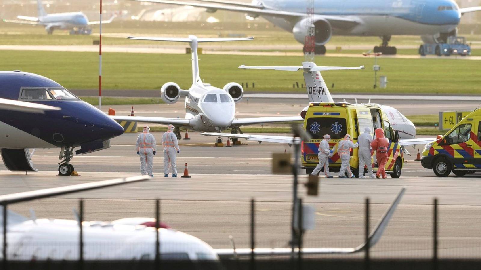 Medics escort a patients, evacuated from the MV Hondius cruise ship with suspected hantavirus infection, to an ambulance after being flown to Schiphol airport, Amsterdam, Netherlands, Wednesday, May 6, 2026.