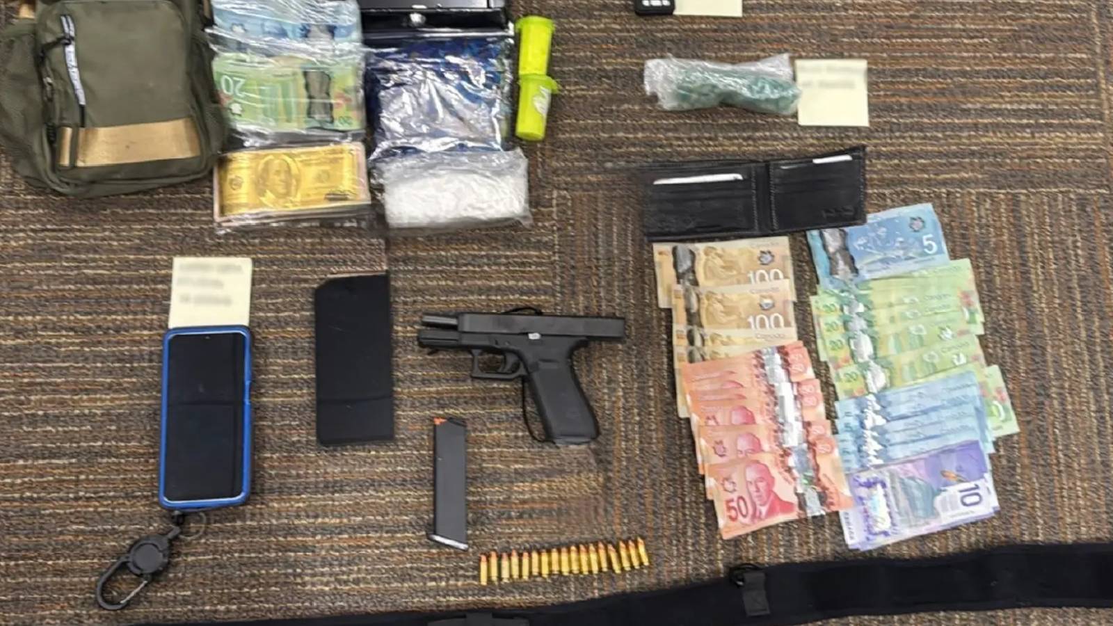 Image of a gun, drugs and cash on a table